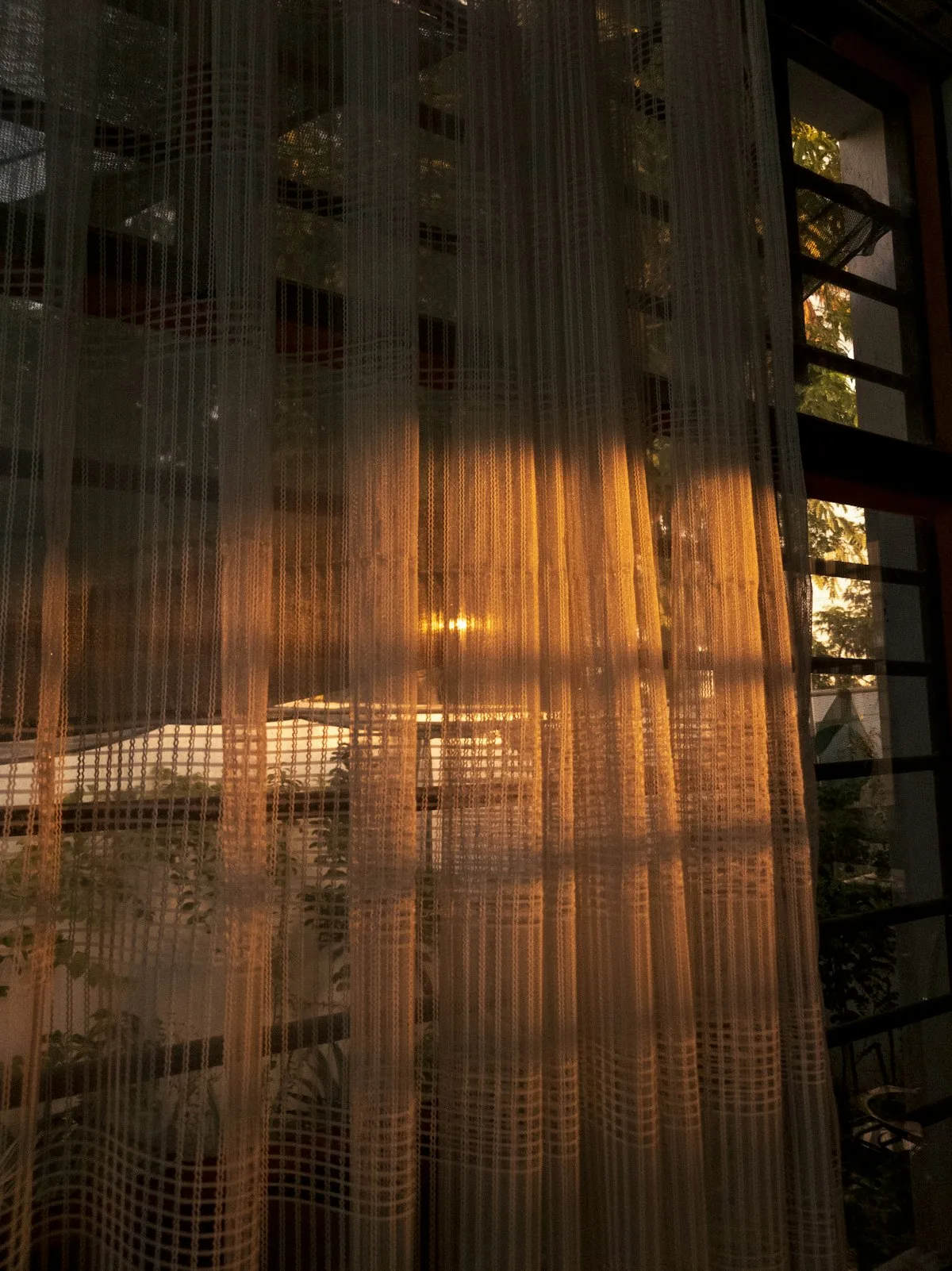 Warm afternoon light through a curtain in a home