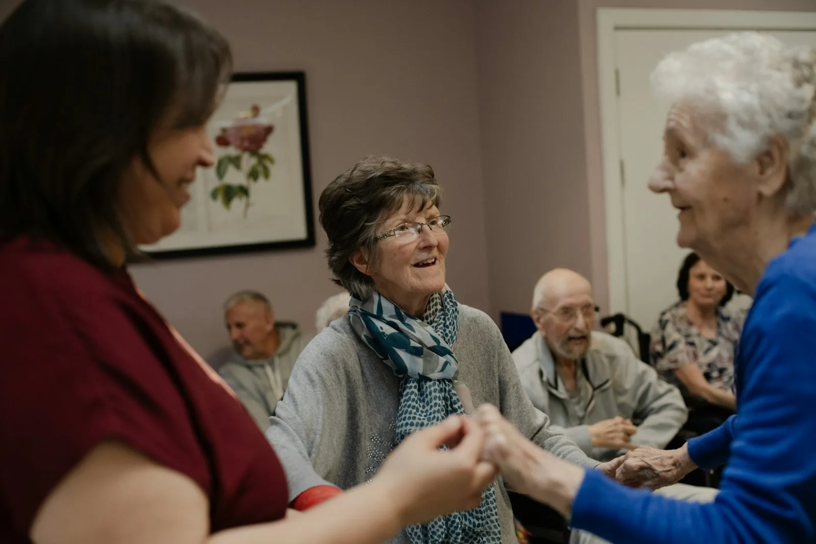 Neighbours holding hands in a circle at a group session