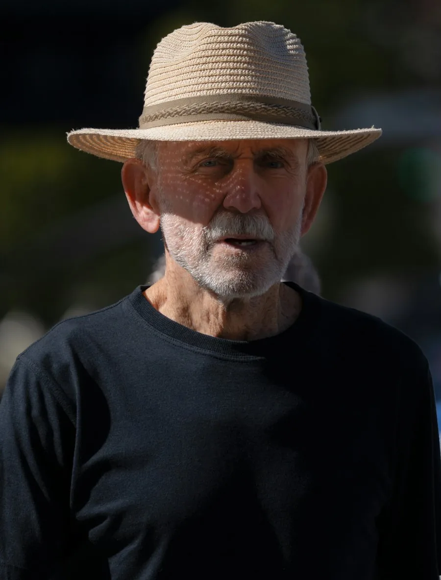 An older man in a straw hat outdoors