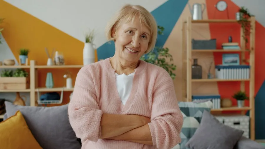 An older woman smiling in her living room