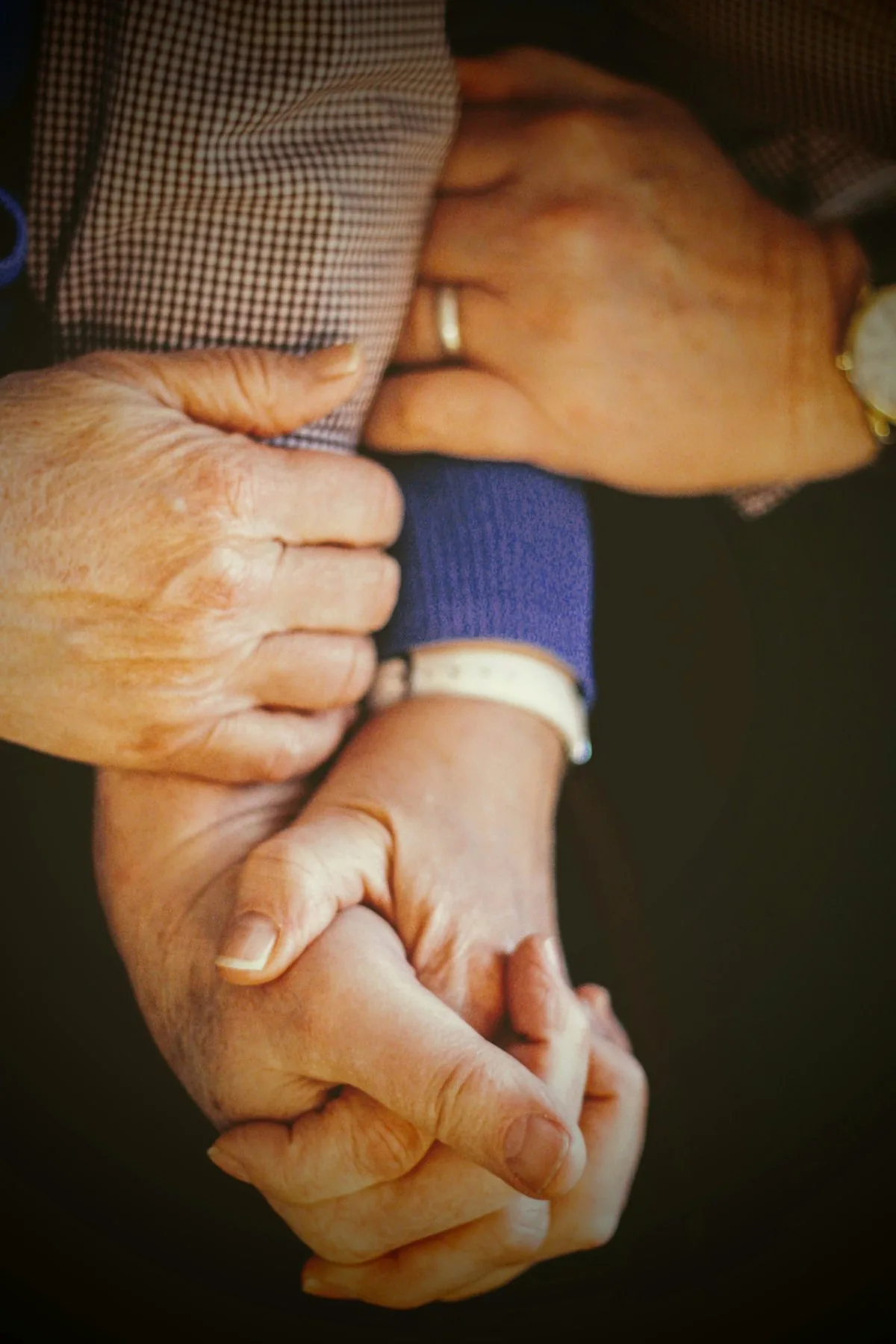 Hands resting together in a gesture of support