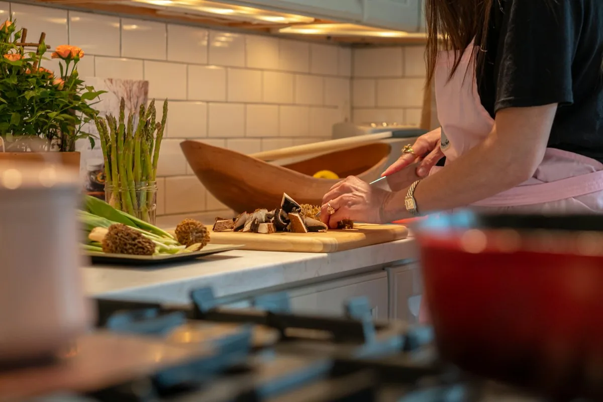 Hands preparing fresh vegetables on a kitchen board