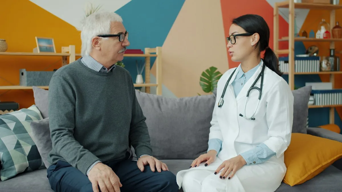 A health worker with a stethoscope talking with an older man at home